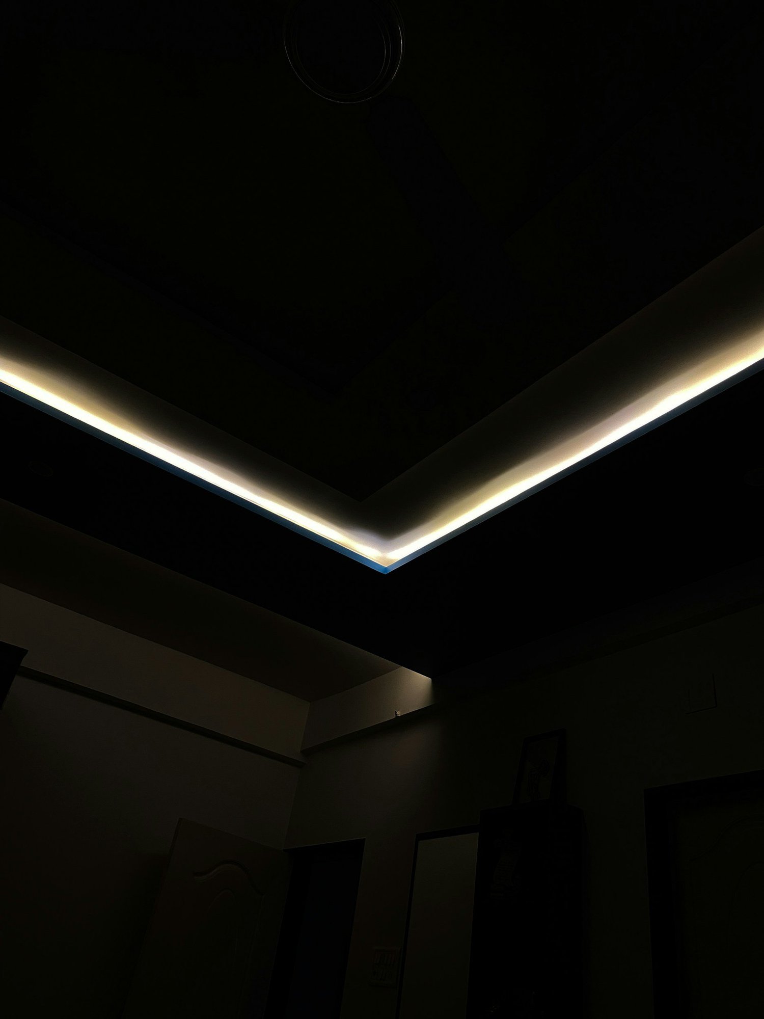 Ceiling cove LED lighting washing a ceiling with warm light, shown as it looks in daylight