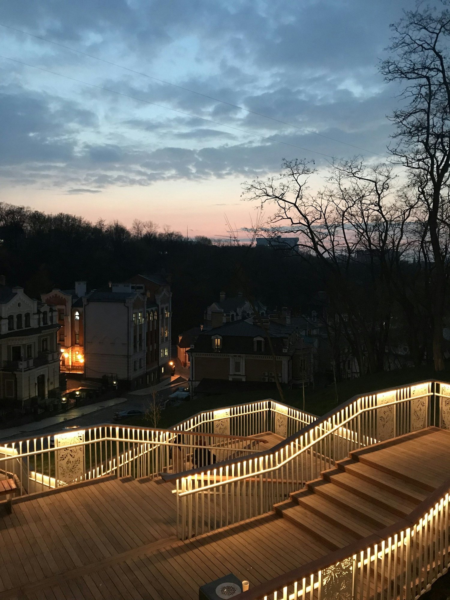 Deck and patio LED lighting over an outdoor entertainment area at night, shown as it looks in daylight