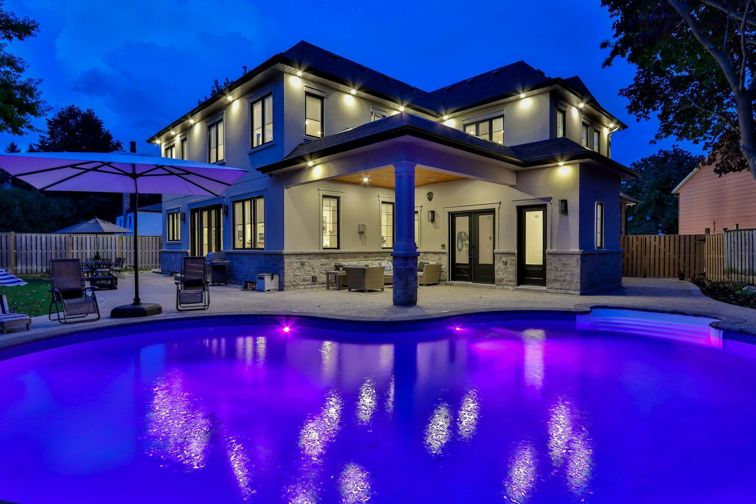 Pool area LED lighting glowing across the water at night, shown as it looks in daylight